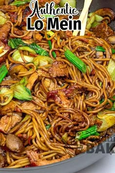 stir fried noodles with meat and vegetables in a wok