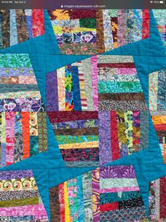 a colorful quilt with many different designs on it