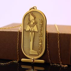 an egyptian gold necklace with the image of pharaoh tutane on it's back