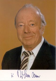 an older man wearing a suit and tie