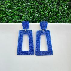 Get ready to bring the glam to your game day style with the Avery. These statement earrings are sure to make a bold statement and add a touch of sparkle to your look. Hypoallergenic stainless steel posts 20mm stud size Lightweight and durable glitter acetate acrylic Studded Necklace, Blue Glitter, Bridal Hair Accessories, Chic Boutique, Game Day, Statement Earrings, Sparkle, Glitter, Stainless Steel