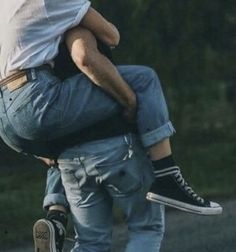 a man carrying a child on his back