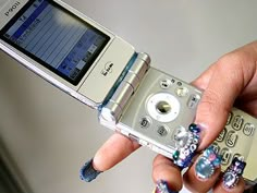 a person holding a cell phone in their hand with designs on the front and sides