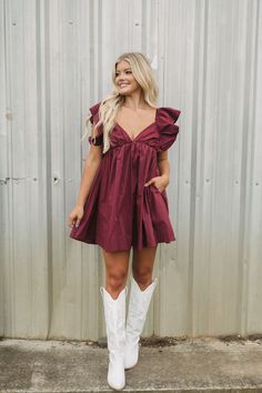 Look and feel your best in this Maroon Poplin Tie Back Dress! With an alluring plunge neckline, flutter sleeves, and side pockets, this dress is sure to turn heads. The fitting silhouette is finished off with a stylish bow-tie back for an extra dose of elegance. Put it on and stand out!   Model is 5'6" with a 34" bust, a 27.5" waist, and 37" hips wearing a size smallruns true to size!    0-2 S, 4-6 M, 8 L    65% cotton, 35% polyester Elegant Western Dresses, Cute Dress With Cowboy Boots, Dressy Cowgirl Outfits, Fall Photoshoot Couple Outfits, Western Cocktail Attire Women, Fall Proposal Outfit, Country Formal Outfits, Country Dress Outfits, Nashville Outfits Fall Night