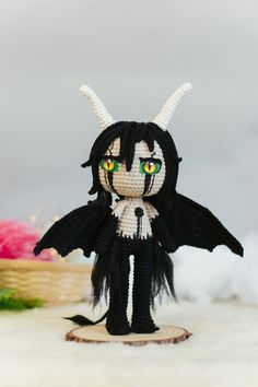 a small black and white doll with green eyes