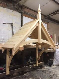 a wooden structure is being built in a workshop