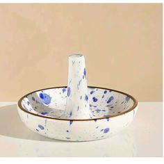 a white bowl with blue spots on it