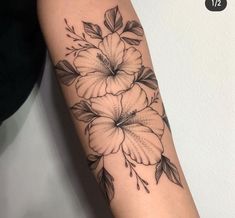 a black and white flower tattoo on the arm