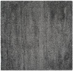 an area rug with dark gray carpeting