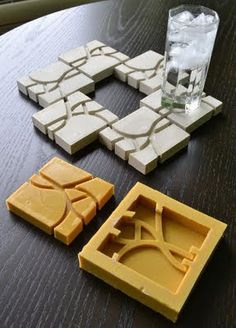 three pieces of cheese sitting on top of a wooden table next to a glass filled with water