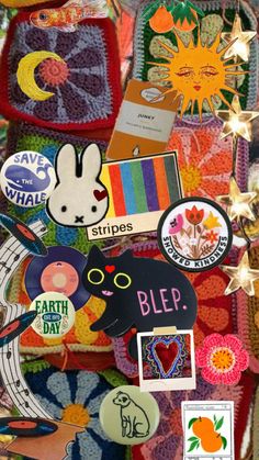 many different stickers and magnets on a blanket