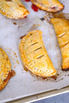 baked pastries sitting on top of a baking sheet