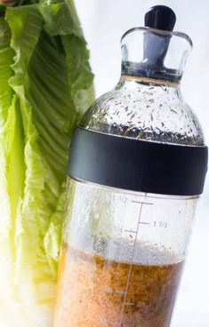 lettuce and seasoning in a blender next to a head of lettuce