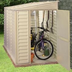 a bike is parked in a storage shed with its door open to reveal the inside