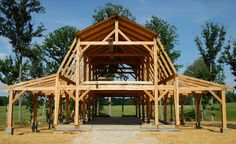 a large wooden structure sitting in the middle of a field