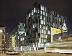 a very tall building with lots of windows on it's side at night time