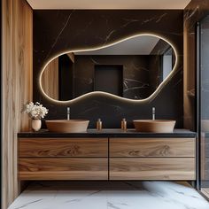 a bathroom with two sinks and a large mirror on the wall next to each other