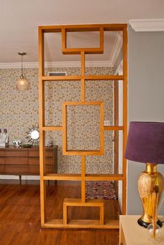 a living room with wood floors and wallpaper