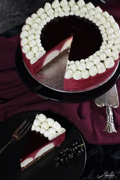 a red velvet cake with marshmallows on top and one slice cut out