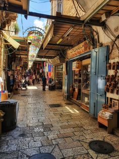 an alley way with shops and people walking around