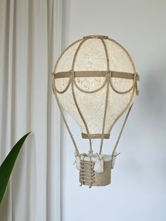 a white hot air balloon hanging from the ceiling