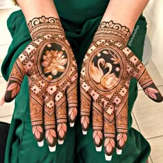 two hands with henna designs on them