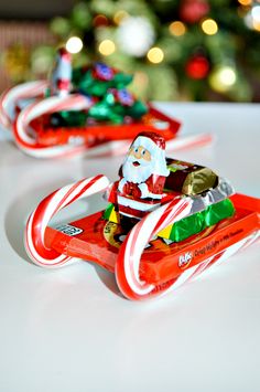 santa claus is riding in a sleigh with candy canes on the side