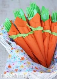 a bunch of carrots wrapped in green and orange paper with ribbon tied around them