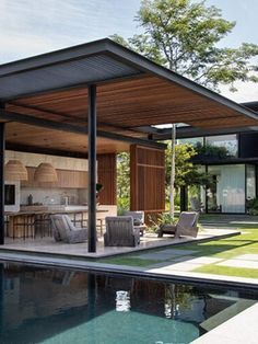 an outdoor living area next to a swimming pool