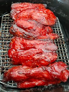 the meat is being cooked on the grill