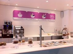 a man standing in front of a counter filled with pastries