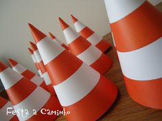 several orange and white striped cones on a table