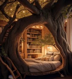 a bed in a tree with lights hanging from it's branches and bookshelves