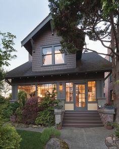 a house that is lit up with the sun coming through the window and on to the front door