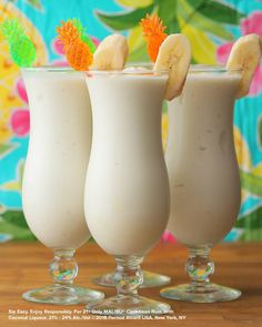 three glasses filled with milk and banana slices