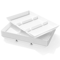 four white plates stacked on top of each other in the shape of rectangles