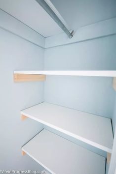 empty white shelves in a room with blue walls