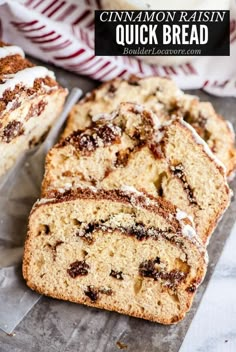 cinnamon raisin quick bread sliced and sitting on a piece of wax paper with the rest of the loaf behind it