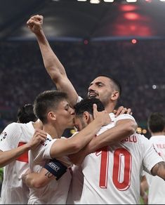 the soccer players are celebrating with each other