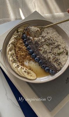 a bowl of oatmeal with blueberries and bananas