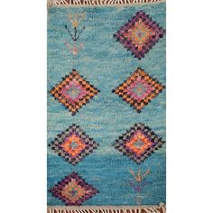 a blue rug with colorful squares and fringes