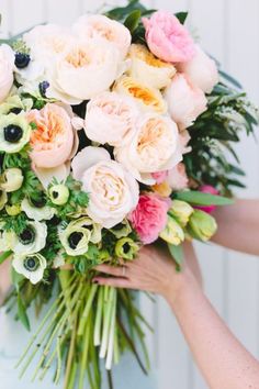 a person holding a bouquet of flowers on top of a cell phone screen with the caption pin it