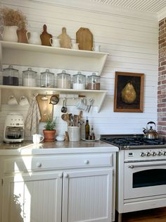 a white stove top oven sitting inside of a kitchen next to a wall mounted oven