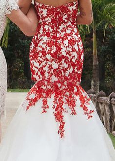 two women dressed in white and red dresses