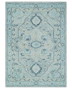 a light blue rug with an intricate design