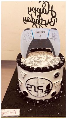 a birthday cake with a video game controller on it's top and the words happy birthday