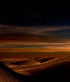 the night sky is filled with stars and clouds over sand dunes in the sahara desert