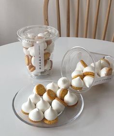 there are some cookies and marshmallows on the table next to each other