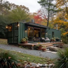 a house made out of shipping containers in the woods