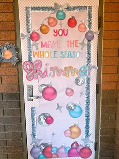 a door decorated with ornaments and the words you make the whole season